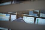 A financial trader monitors data on computer screens on the trading floor.
