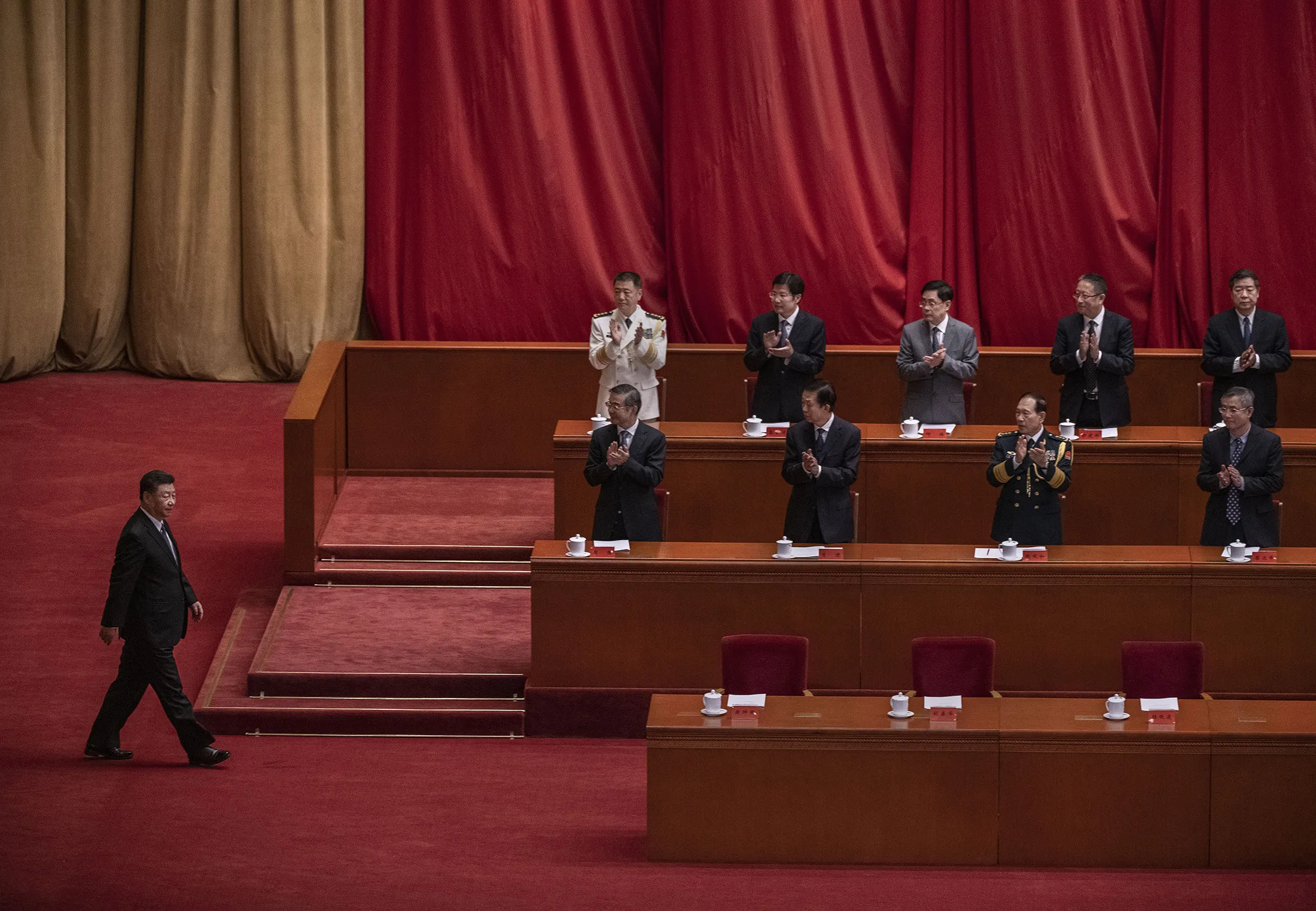 Xi Jinping, left, is applauded by senior members of the government at the Great Hall of the People in Beijing in October.