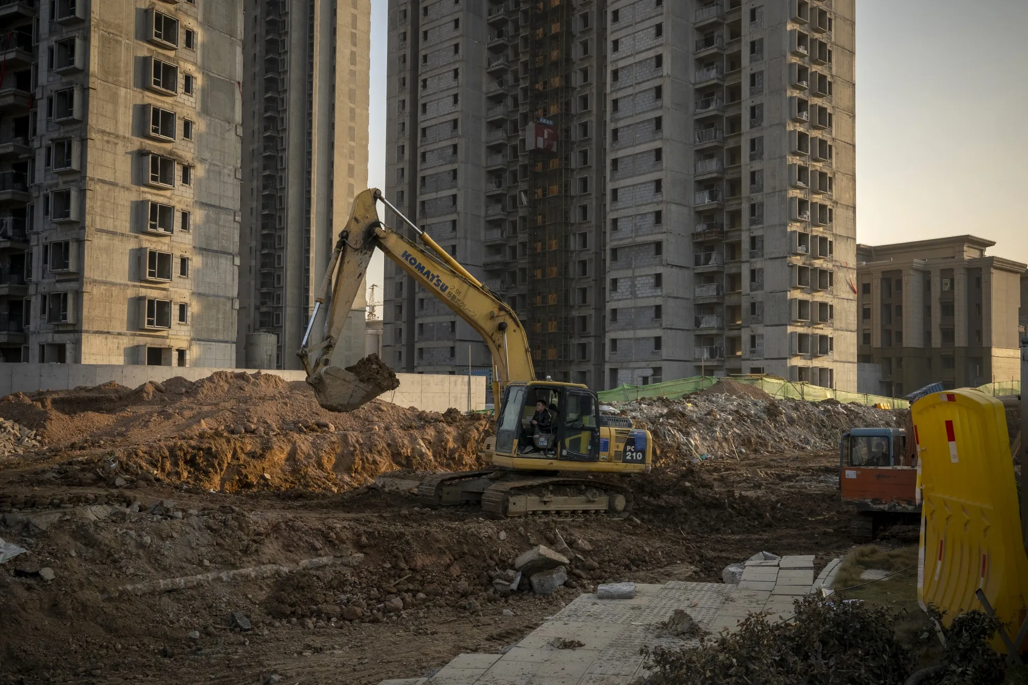 A worker operates an excavator at the construction site of a China Evergrande Group development in Wuhan, China, on Dec. 22.