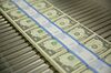 Stacks of $1 dollar notes bearing the name of U.S. Treasury Secretary Steven Mnuchin move through a machine at the U.S. Bureau of Engraving and Printing in Washington, D.C., U.S., on Wednesday, Nov. 15, 2017. A change in the Senate tax-overhaul plan that would expand a temporary income-tax break for partnerships, limited liability companies and other so-called "pass-through" businesses won the endorsement of a national small-business group today.