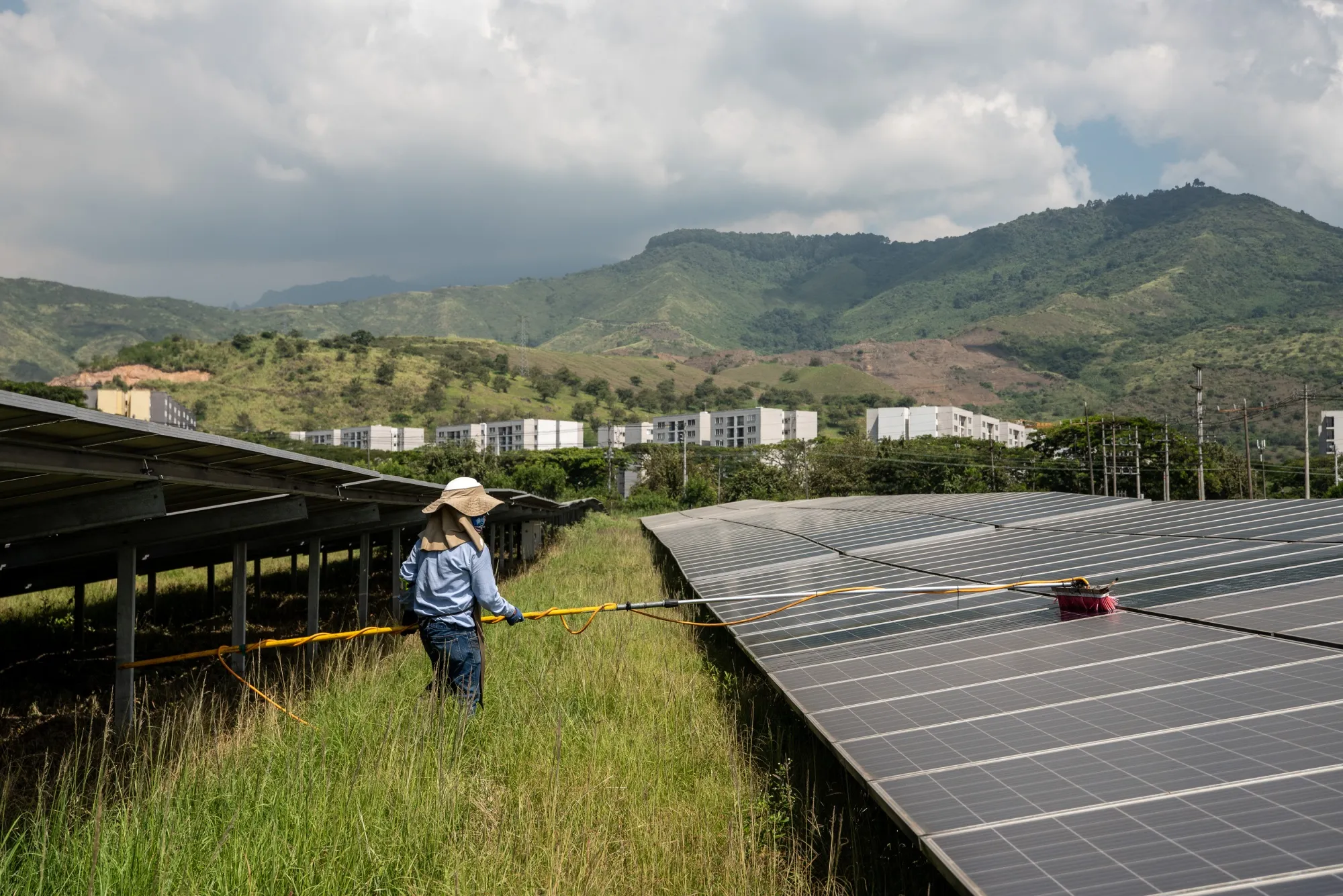 A worker cleans solar panels at the Celsia solar farm facility in Yumbo, Valle del Cauca department, Colombia.