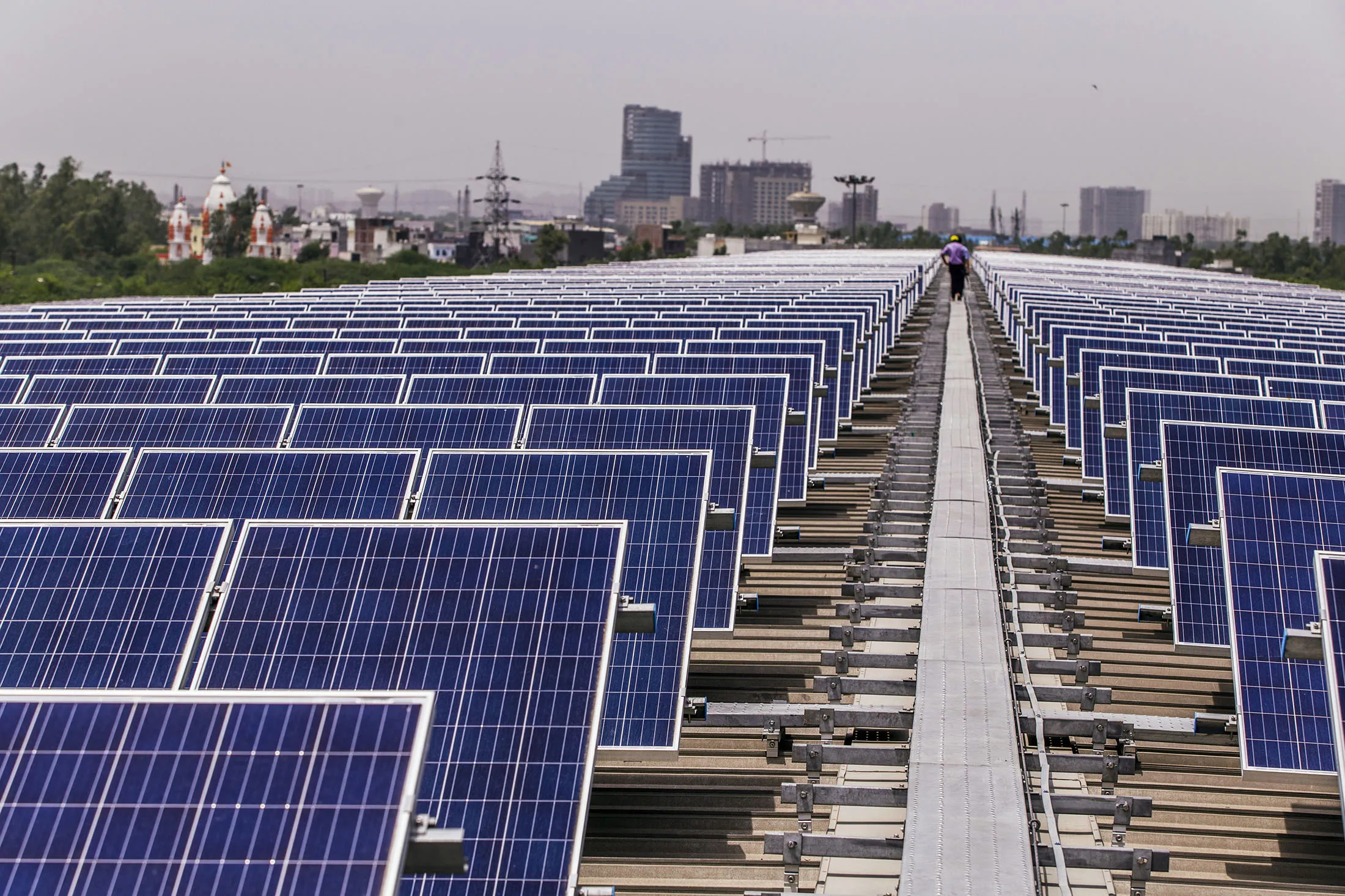 Solar panels implemented by Amplus Solar stand on the roof of the Yamaha Motor Co. plant in Surajpur, Uttar Pradesh, India, on Wednesday, July 20, 2016. The Japanese motorcycle maker wants solar power to supply a quarter of energy needs at its northern Indian factories near Delhi, according to company executives.

