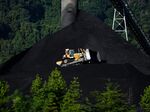 A bulldozer operates on a coal mound at a coal preparation plant in London, West Virginia.