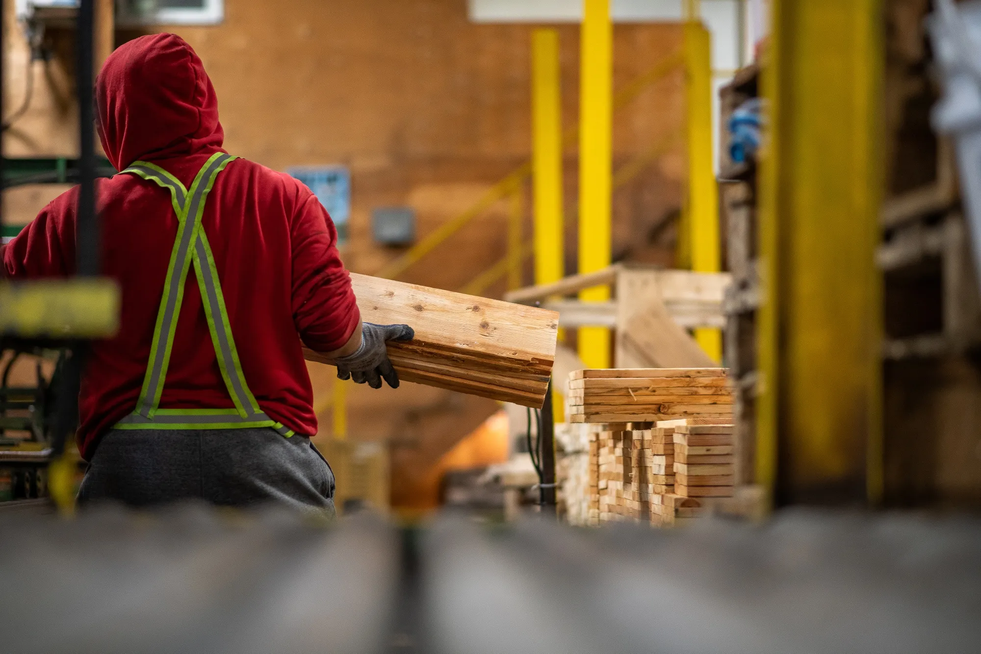 A worker loads&nbsp;wood onto pallets in Abbotsford, British Columbia, Canada.
