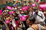 Attendees hold signs supporting Planned Parenthood during the NYC Pride March in New York on June 26.
