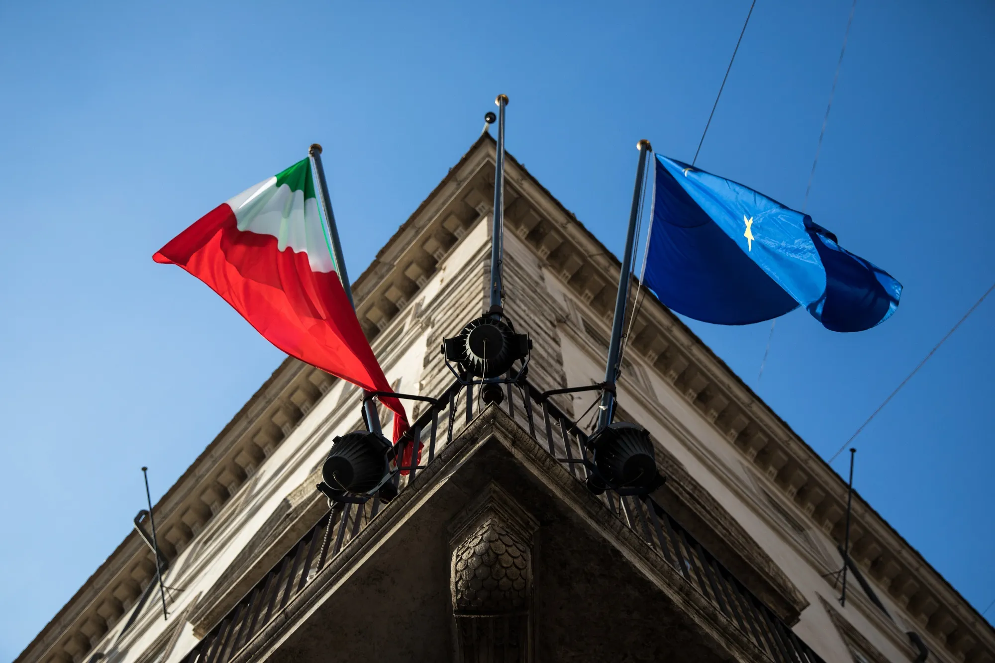 The&nbsp;Italian flag&nbsp;flies alongside the European Union flag from the Palazzo Chigi in Rome.