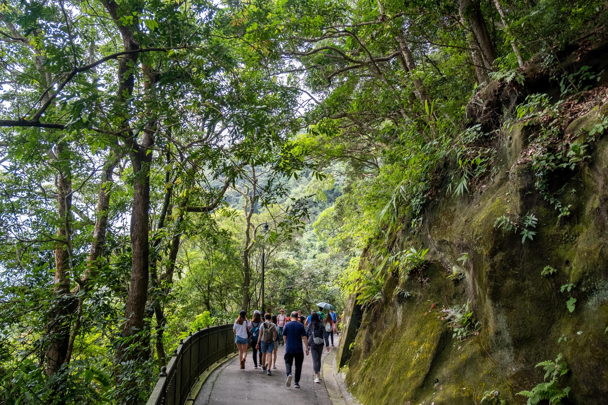 People walk on the trail from Harlech Road to High West in Hong Kong on Sept.&nbsp;26.