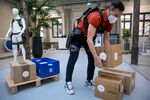 A user demonstrates a Paexo Back exoskeleton device at the Ottobock SE &amp; Co. KGaA office in Berlin, Germany.