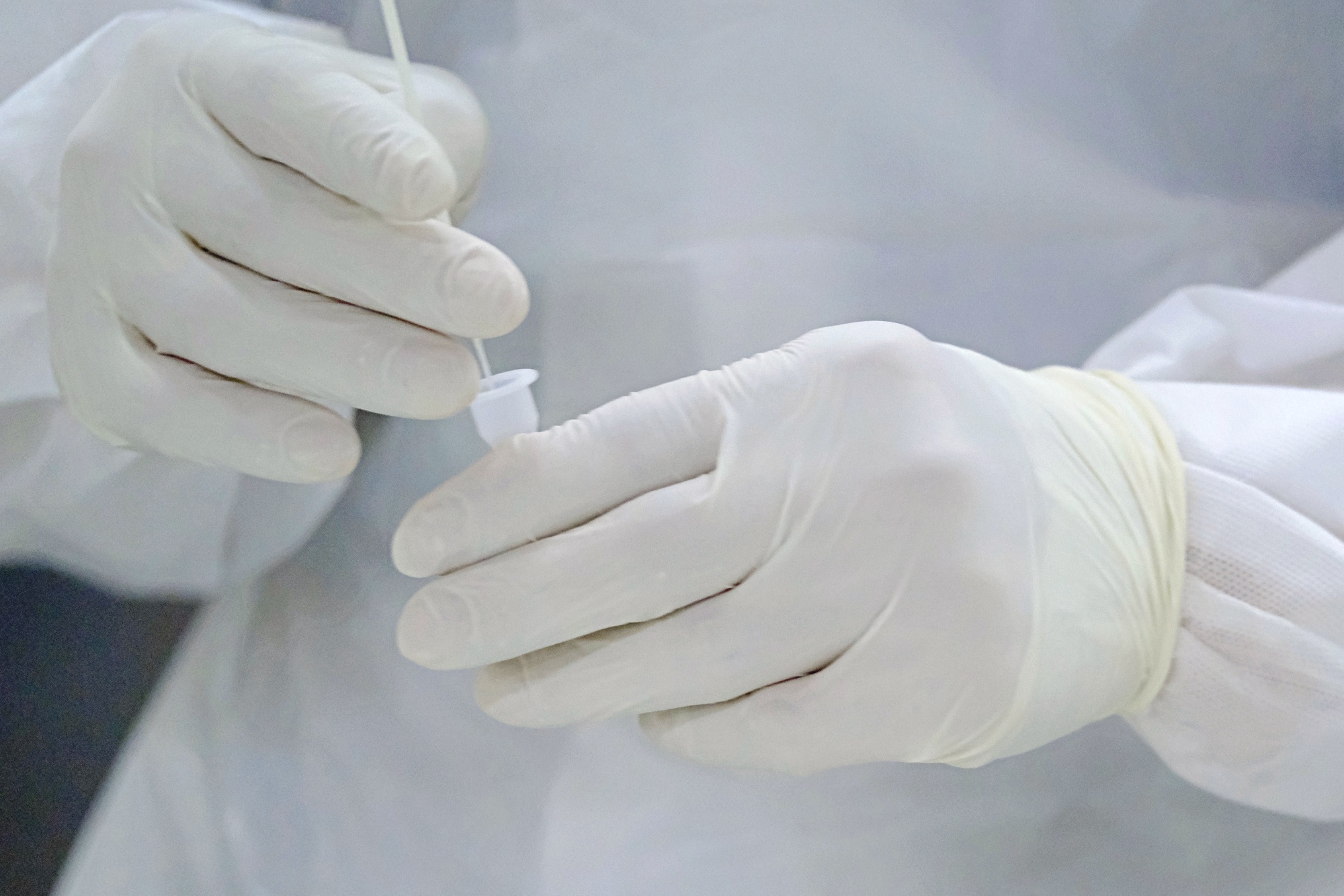 A health worker holds a Covid-19 swab sample.