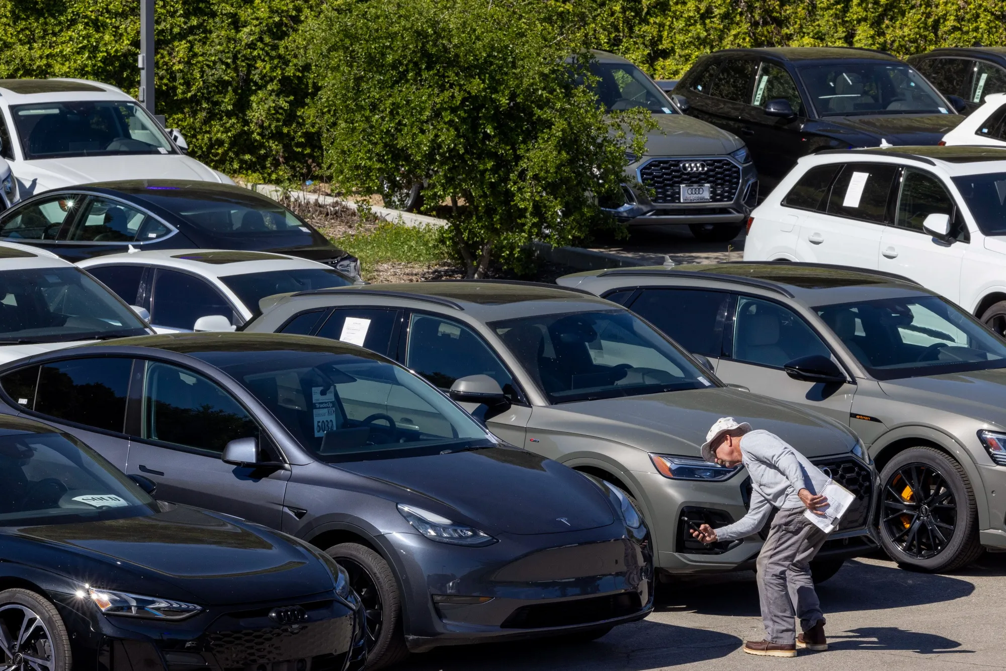 A customer looks at a used Tesla electric vehicle for sale at a dealership in Calabasas, California.