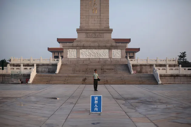 A Chinese paramilitary policeman stands guard at the Monument to the People’s Heroes in Tiananmen Square