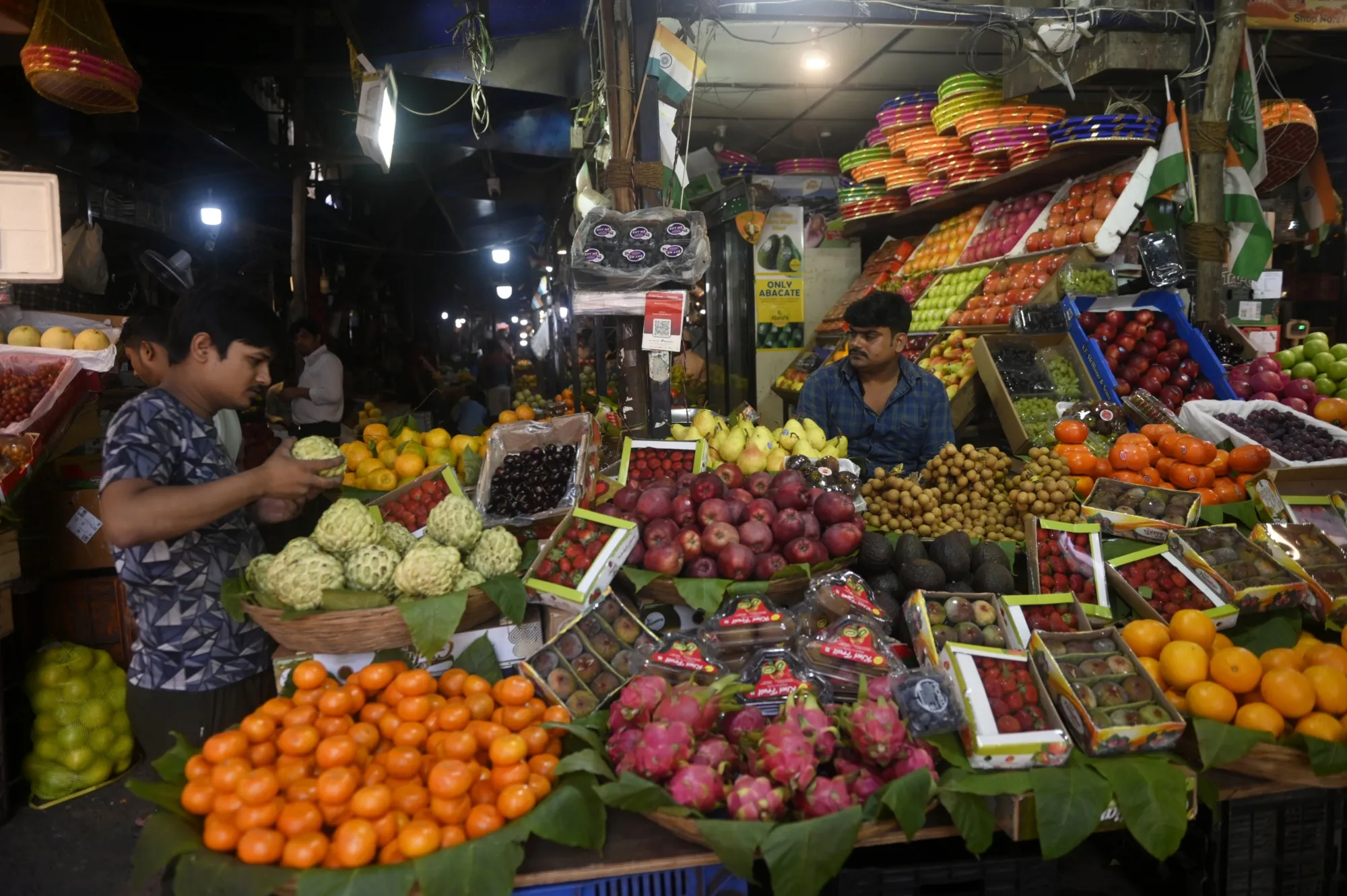 A customer browses fruit at a market stall in Mumbai, India.