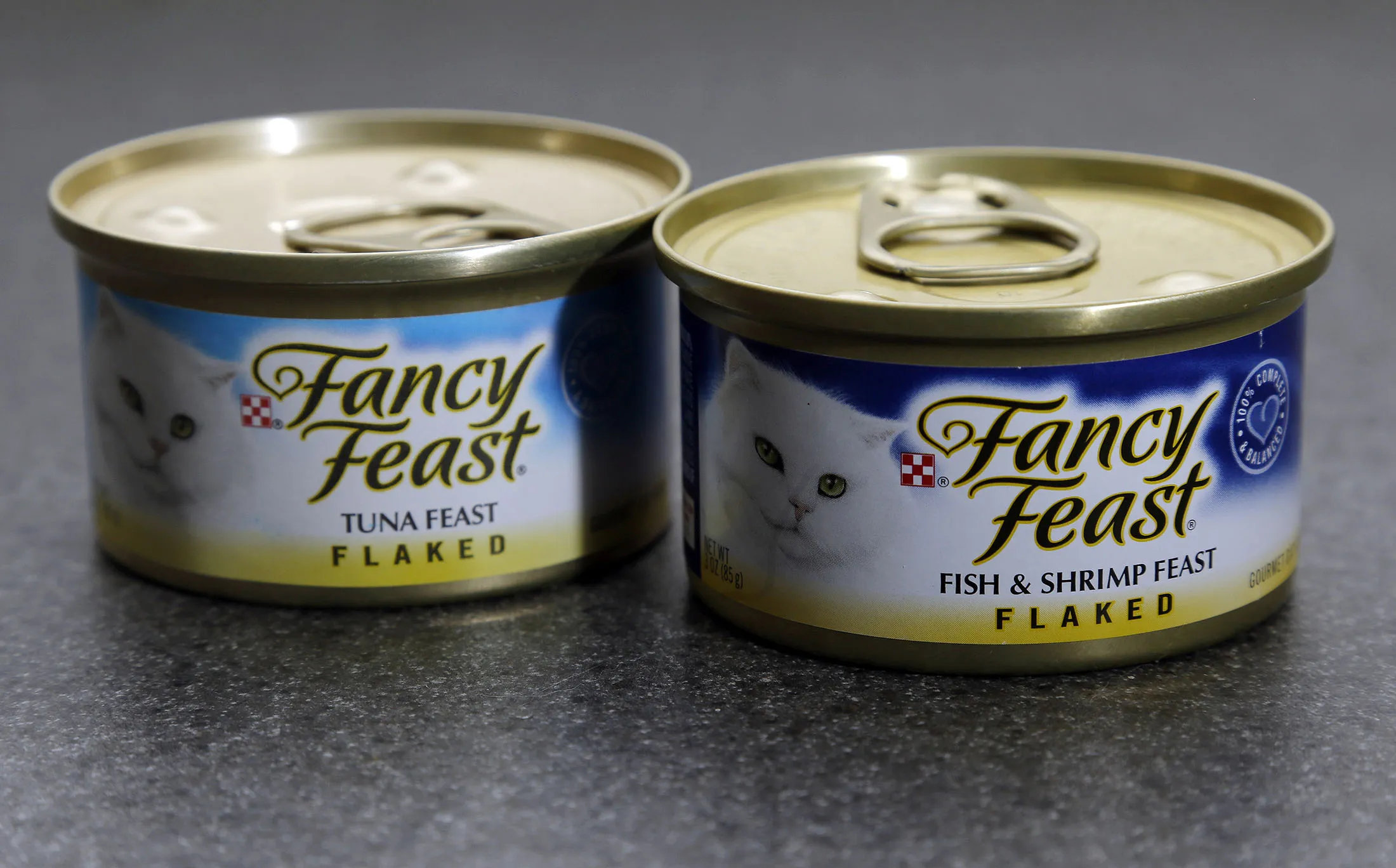 Fancy Feast cat food cans are arranged for a photograph.
