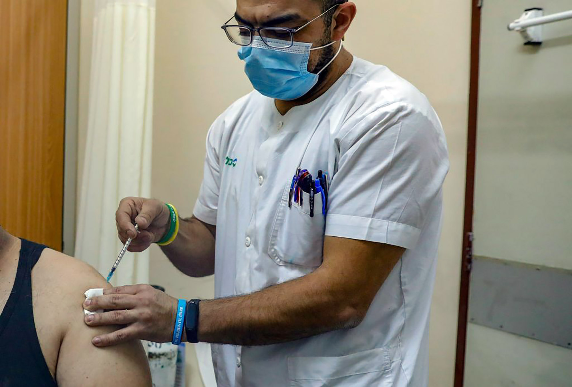 A Palestinian man receives the Pfizer-BioNTech COVID-19 vaccine in Jerusalem.&nbsp;