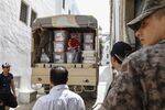 Men stand next to ballot boxes and election materials in a truck, during presidential elections in Tunisia on Sept. 15.