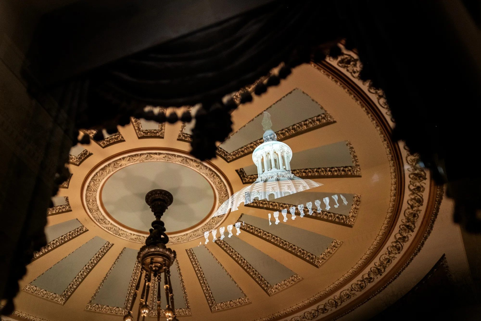 The U.S. Capitol dome reflected at the Ohio Clock Corridor in Washington.