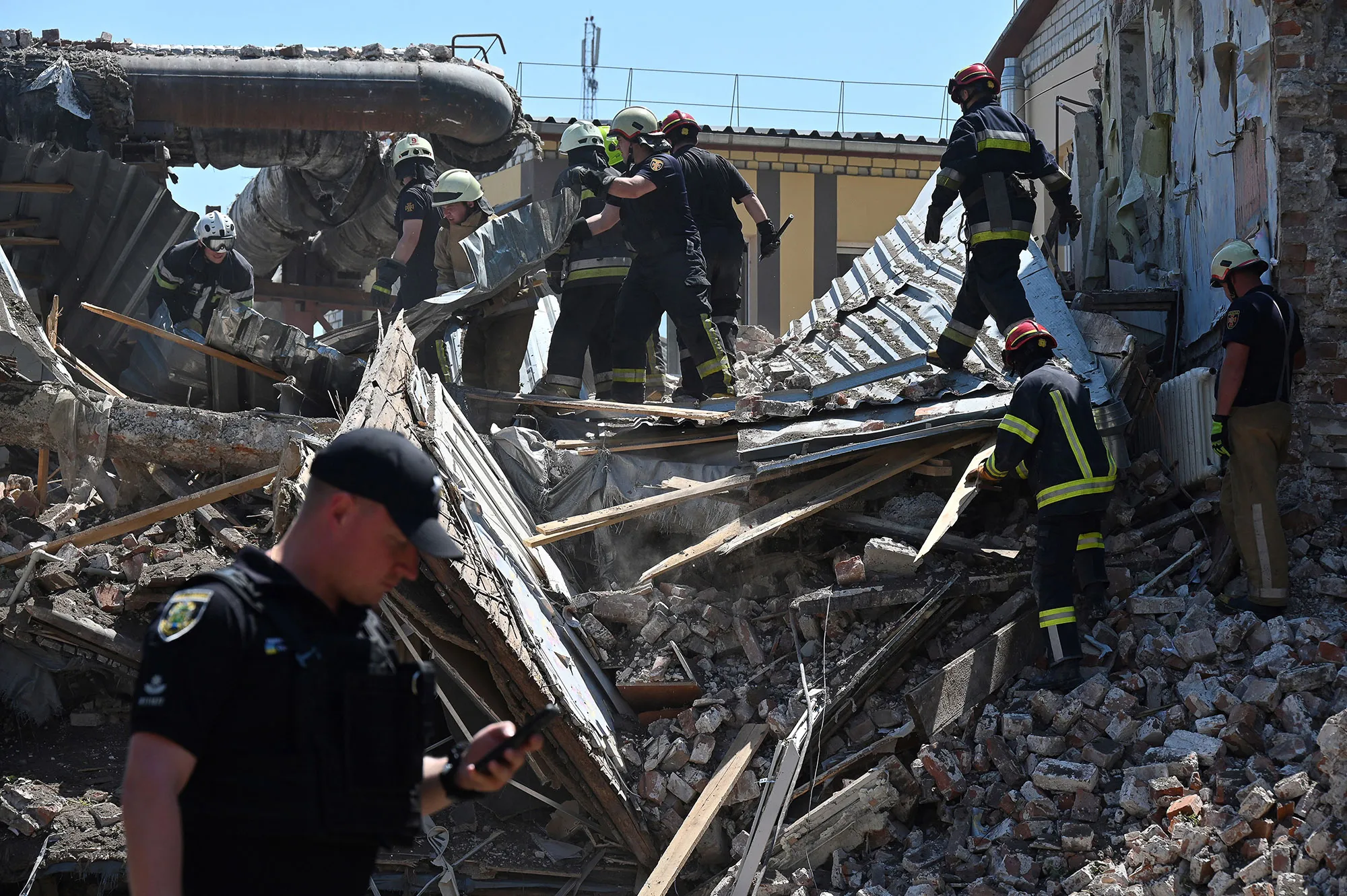Ukrainian rescuers clear debris of residential buildings destroyed by a missile strike in Kharkiv, on July 9.&nbsp;