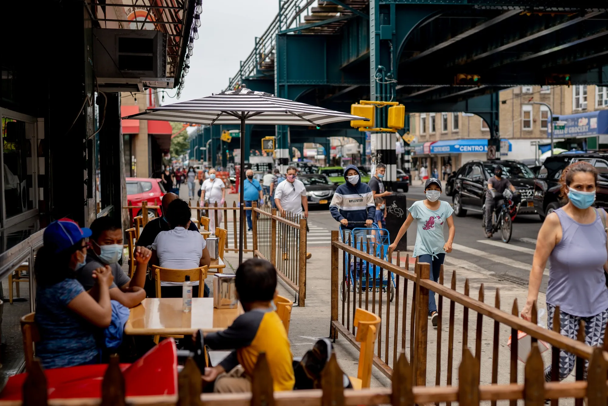 Customers sit outside to eat at a restaurant in New York.