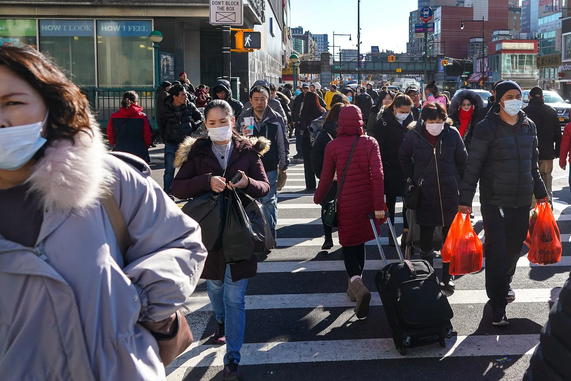 Some pedestrians wear face masks in Queens, New York.&nbsp;
