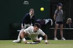 Serbia's Novak Djokovic falls while attempting to return the ball to Tim van Rijthoven of the Netherlands during a men's fourth round singles match on day seven of the Wimbledon tennis championships in London, Sunday, July 3, 2022.(AP Photo/Kirsty Wigglesworth)