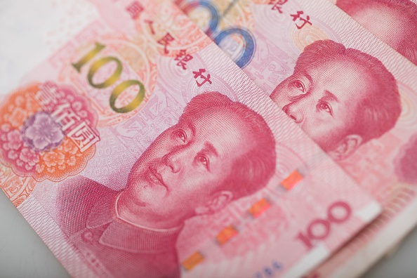 China Yuan of Mao dollar bank note are arranged for a photograph. 