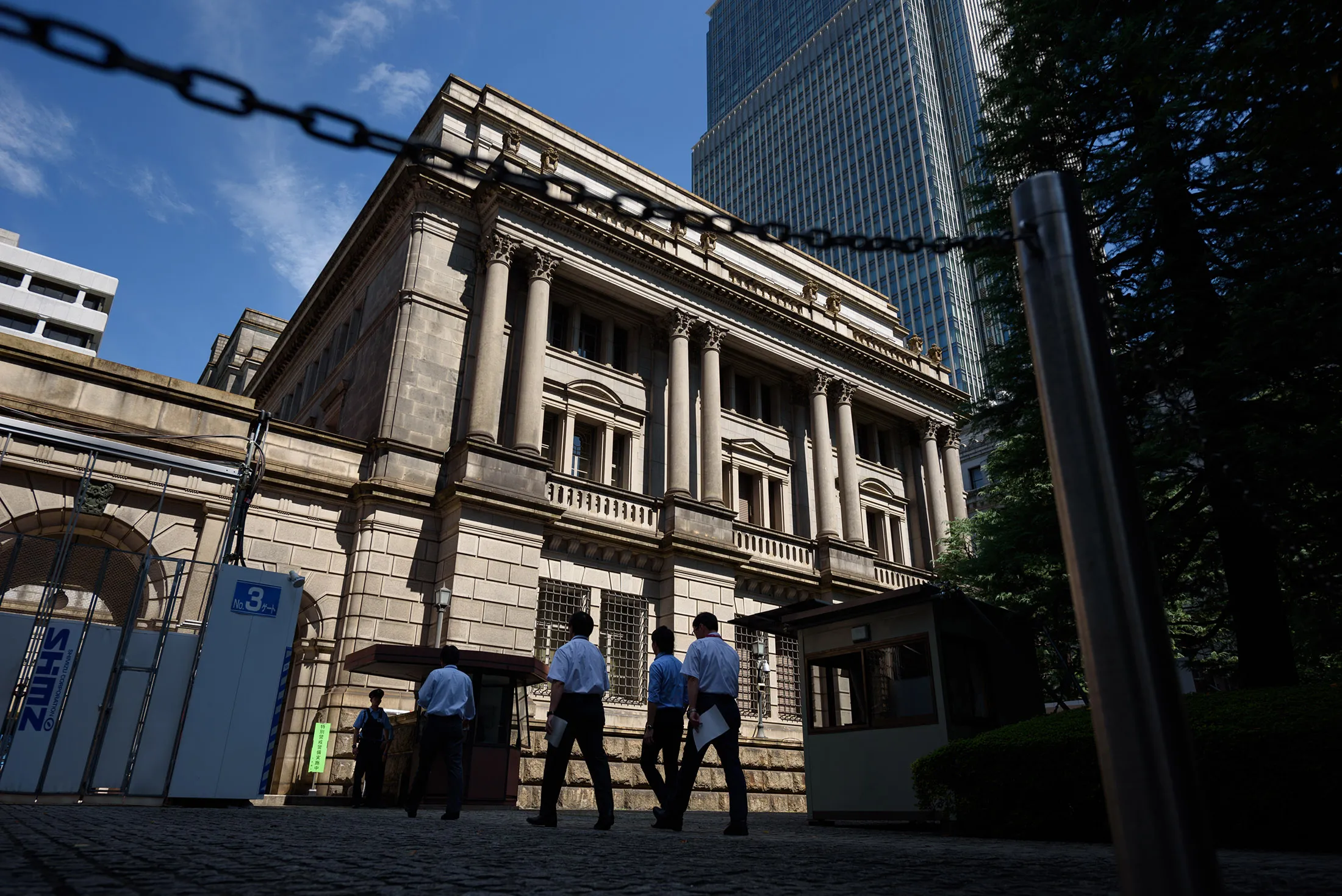 People enter the Bank of Japan (BOJ) headquarters in Tokyo, Japan, on Wednesday, Sept. 13, 2017. The BOJ's next monetary policy meeting is scheduled for Sept. 21. The central bank pushed back in July the projected timing for reaching its 2 percent inflation target for the sixth time as economic growth failed to drive price gains.