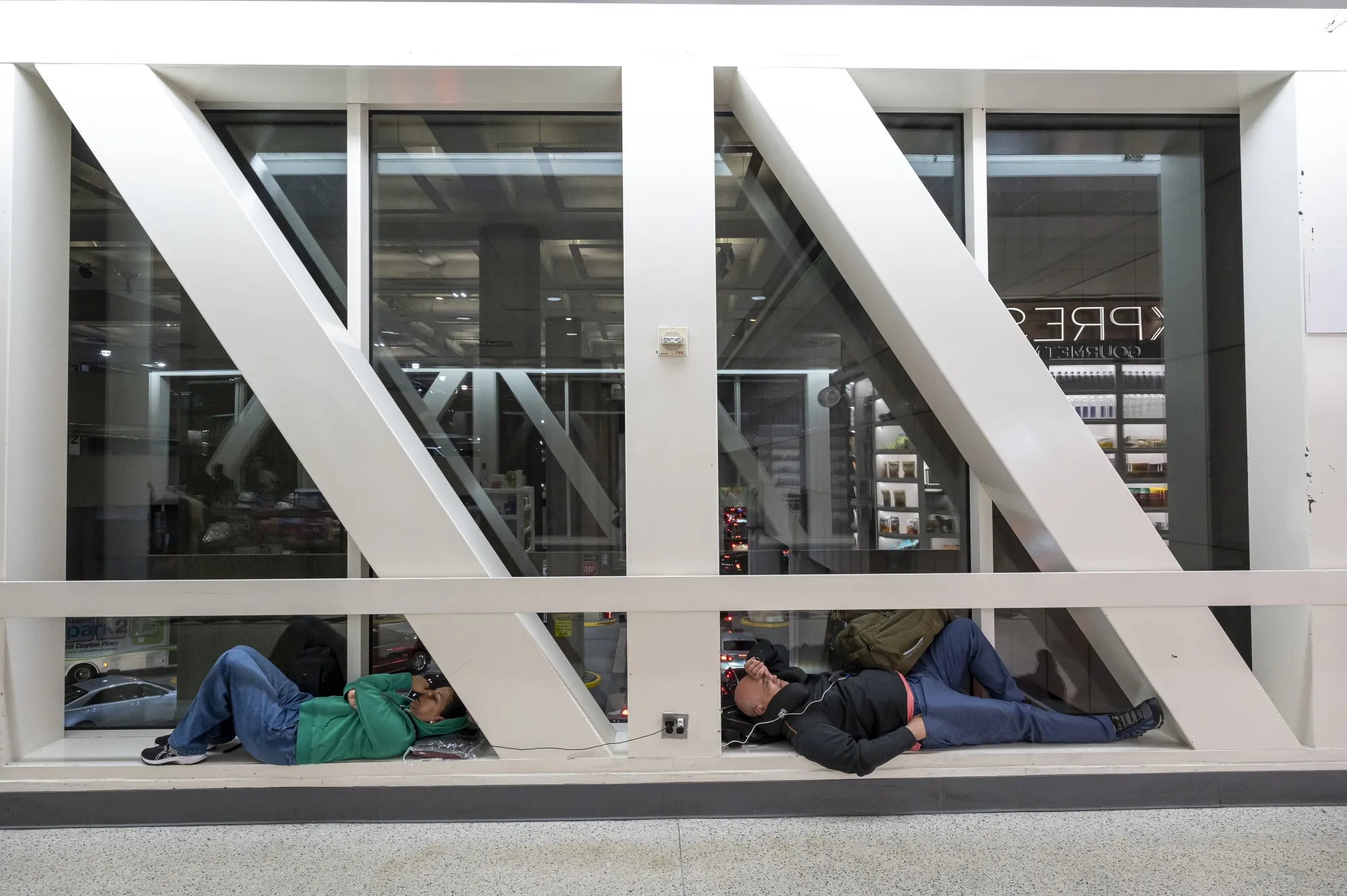 Passengers rest at George Bush Intercontinental Airport, in Houston, Texas, on Friday after a widespread global computer outage grounded planes and created chaos at airports.