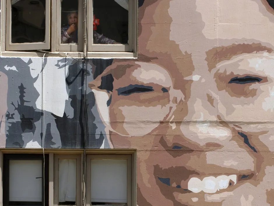 Chinese immigrants look out of their apartment windows in San Francisco. 