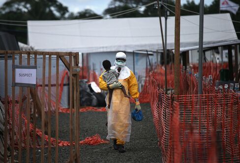 A Health Worker Carries a Child Suspected of Having Ebola