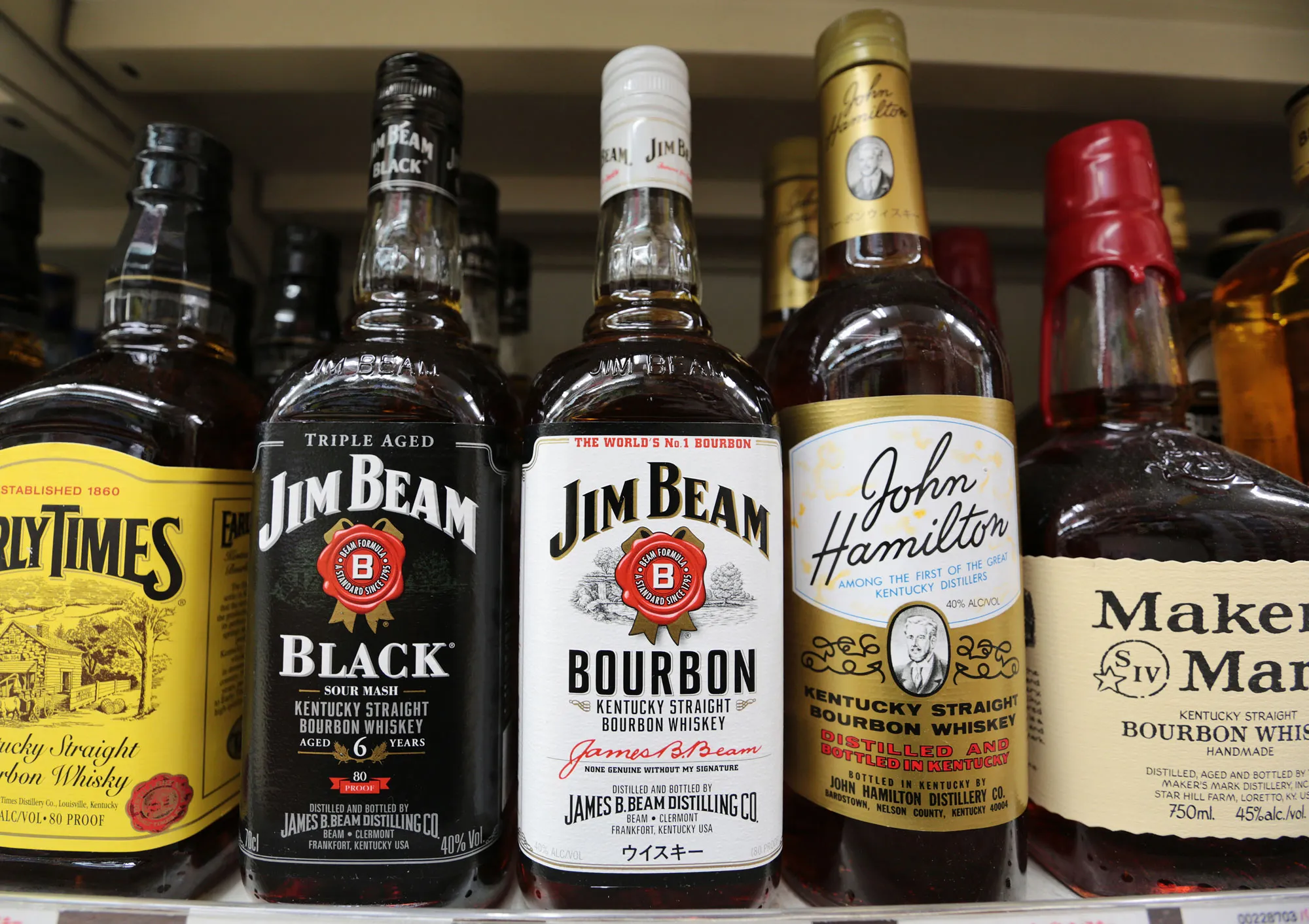 Bottles of Beam Inc.'s Jim Beam bourbon whiskey, second left and center, and Maker's Mark bourbon, right, are displayed for sale at a liquor store in Tokyo, Japan, on Tuesday, Jan. 14, 2014.
