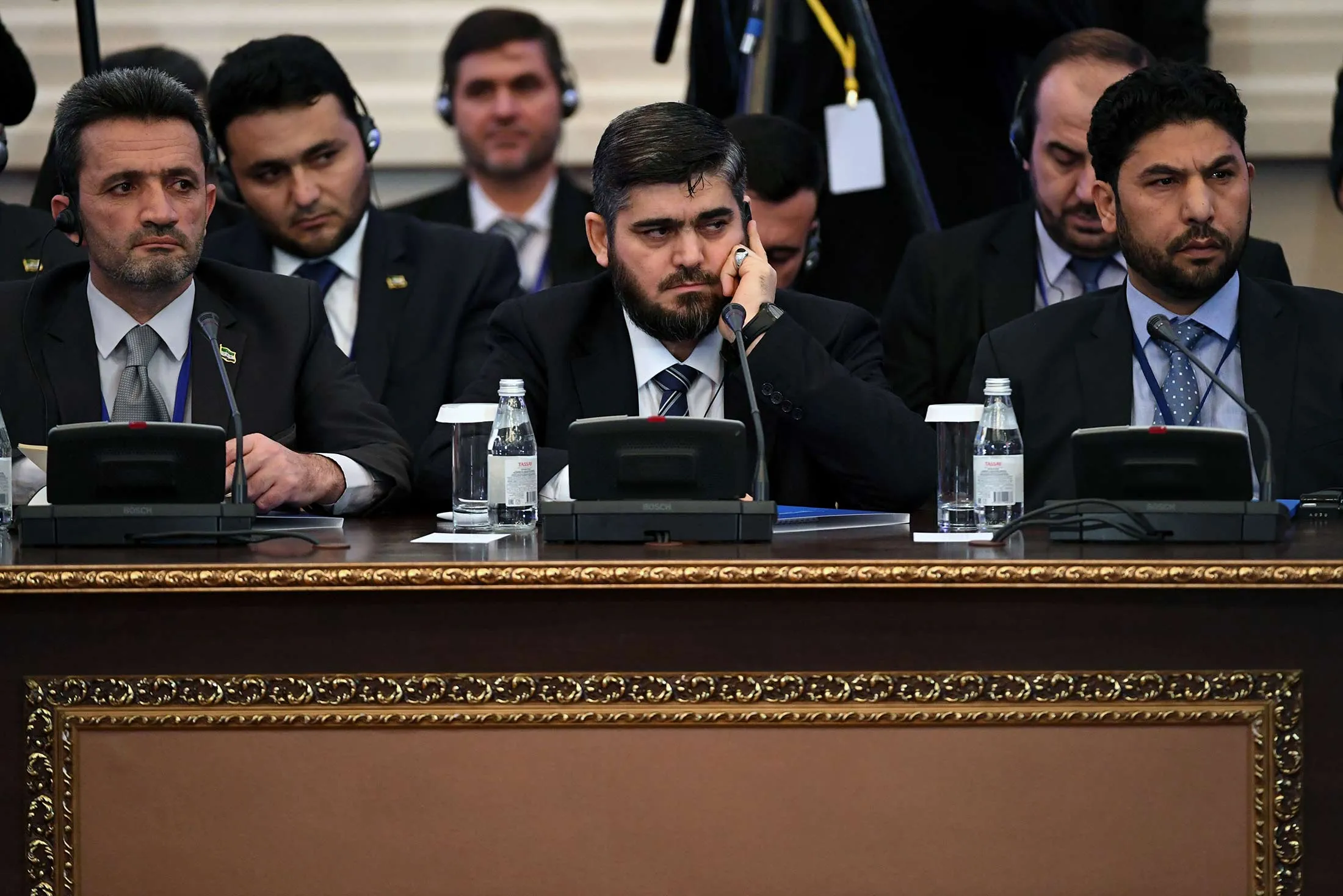 Chief opposition negotiator Mohammad Alloush, center, of the Jaish al-Islam (Army of Islam) rebel group attends the first session of Syria peace talks at Astana's Rixos President Hotel on Jan. 23.
