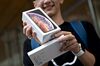 A customer displays an Apple Inc. iPhone XS Max box.