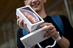 A customer displays an Apple Inc. iPhone XS Max box.