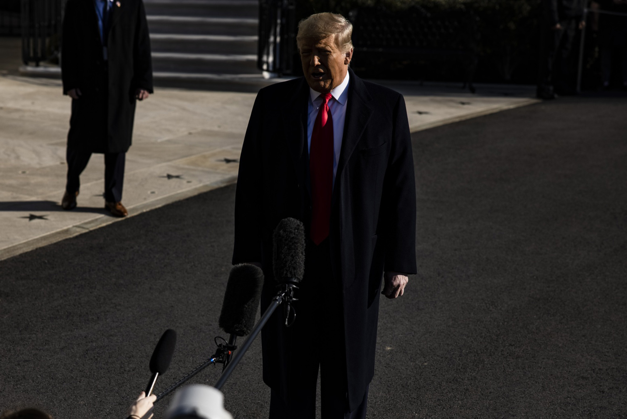 Donald Trump speaks to members of the media as they leave the White House in Washington, DC on January 12.