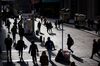 Pedestrians walk along Wall Street near the New York Stock Exchange (NYSE) in New York, U.S., on Monday, March 5, 2018. U.S. stocks turned higher and Treasuries erased gains as investors speculated that President Donald Trump's tough tariff talk won't translate into the most severe protectionist policies.