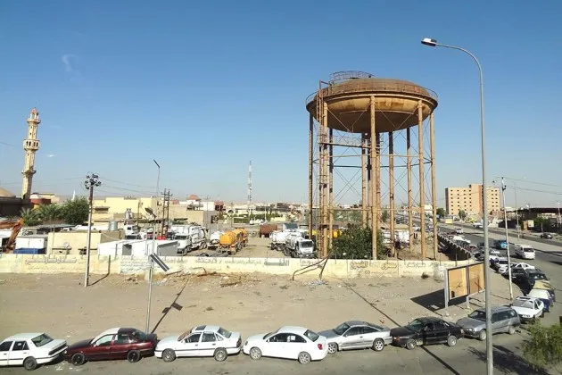 Vehicles wait to fill their cars with gasoline in the northern oil hub city of Kirkuk on July 1