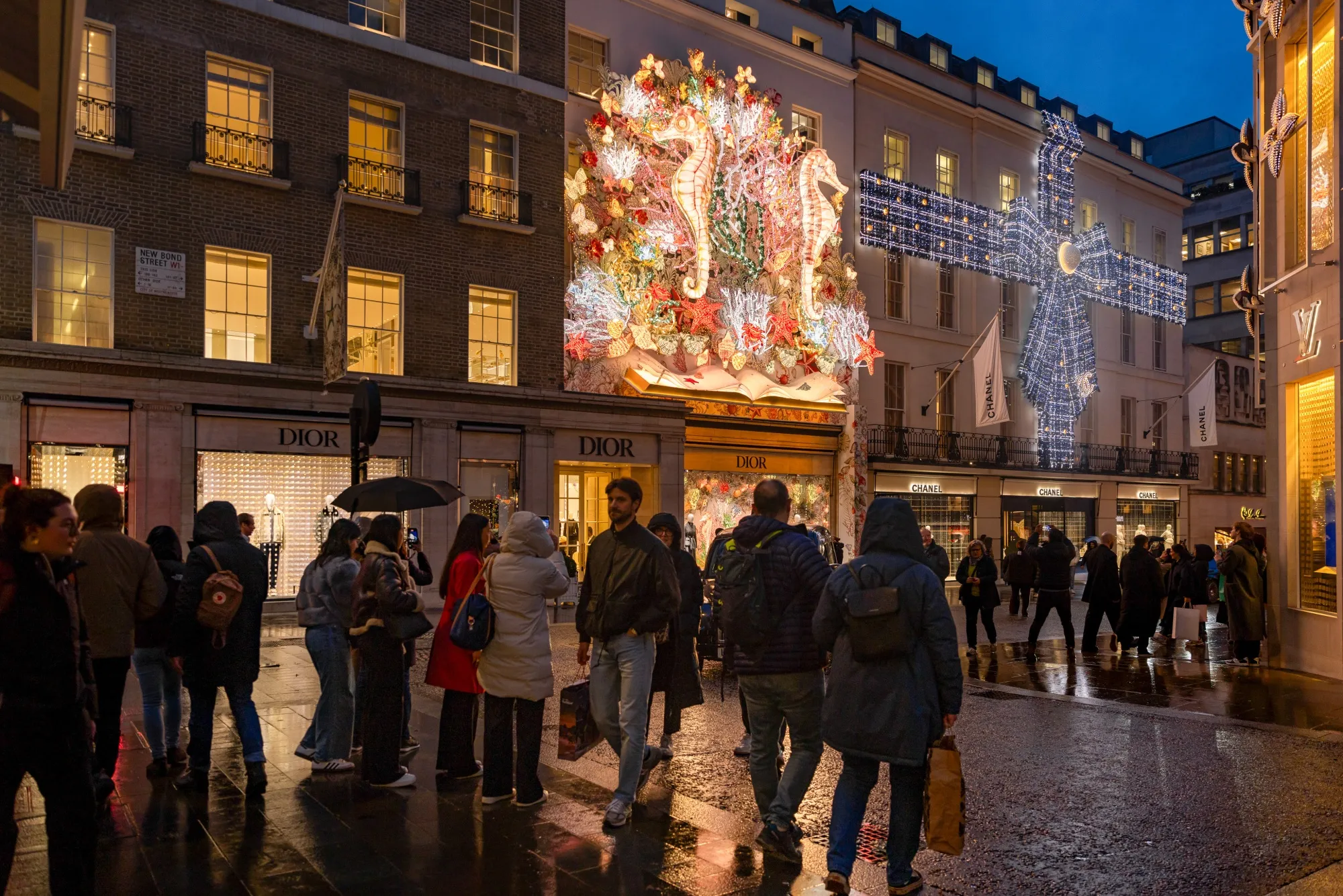 Shoppers pass the Dior store on New Bond Street in London.