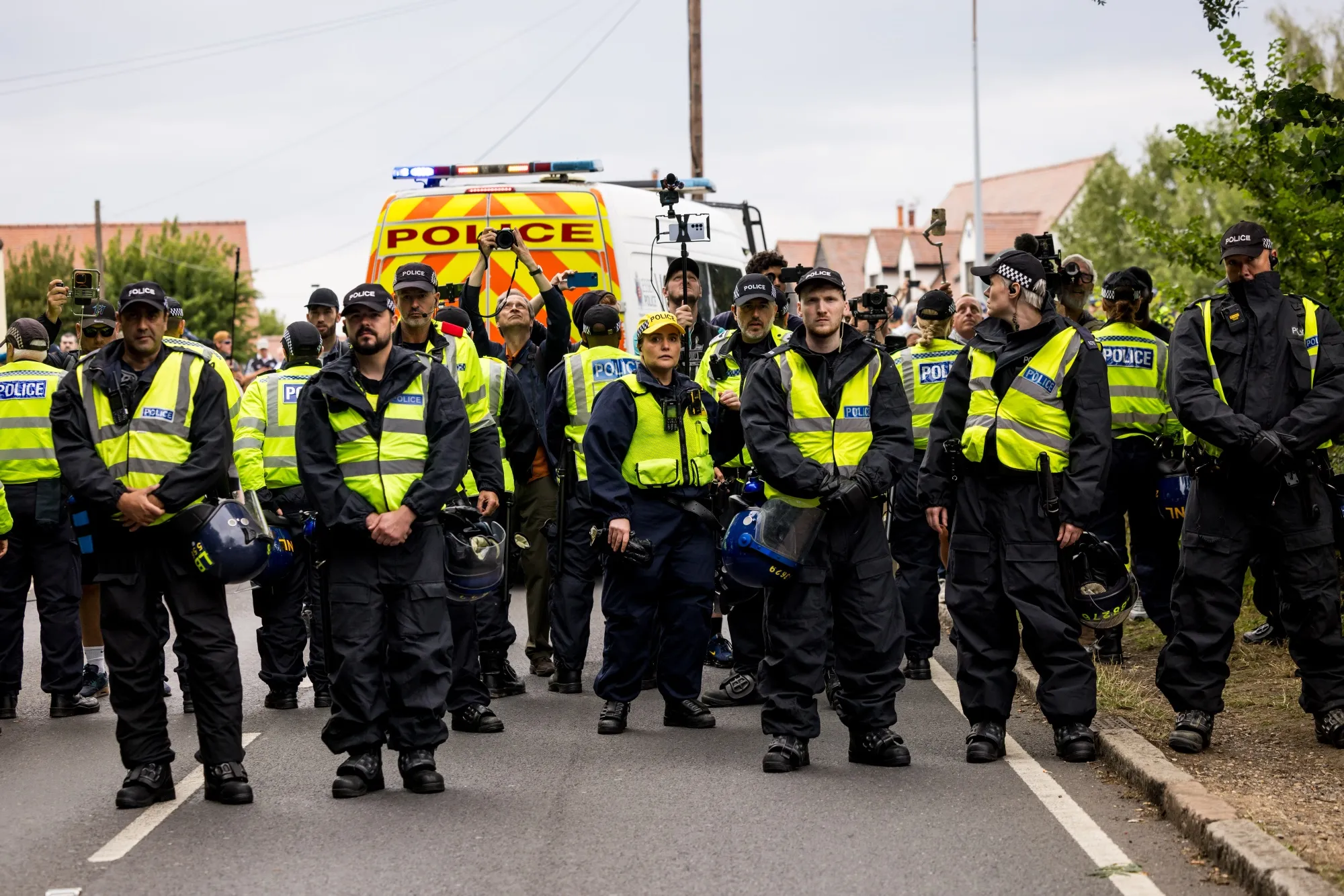 Police look on as protesters gather.