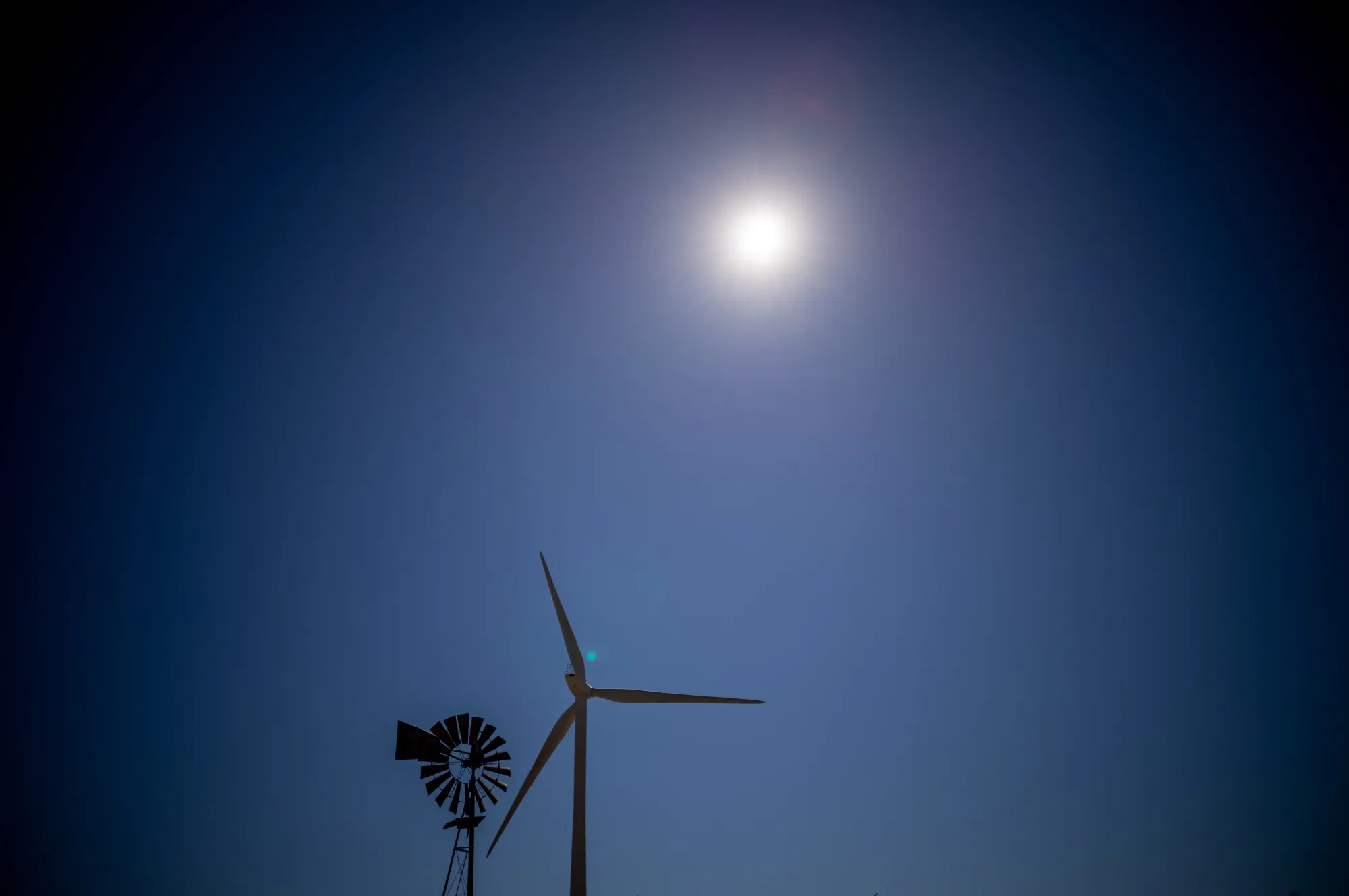A windmill near a wind turbine in Rio Vista, California, US