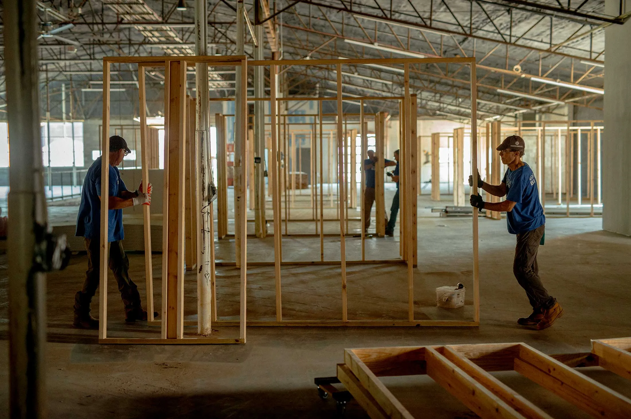 Volunteers and workers rebuild walls in the Marquee, a retail art space, in July.