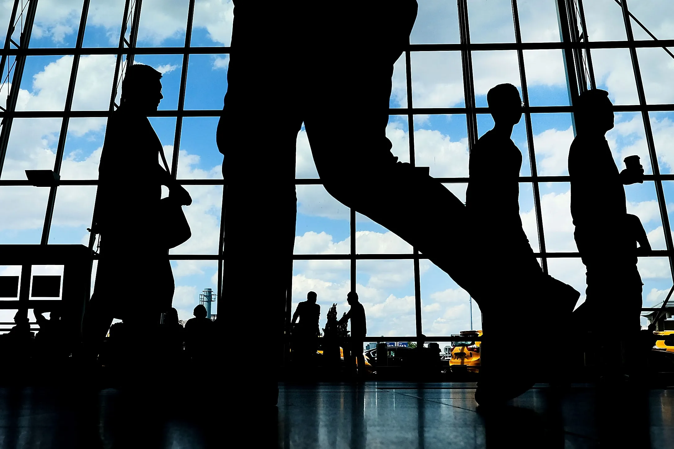 People walk through international arrivals at JFK airport in New York City.&nbsp;
