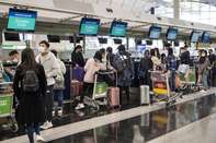 Passengers check-in for Singapore Airline at Hong Kong's