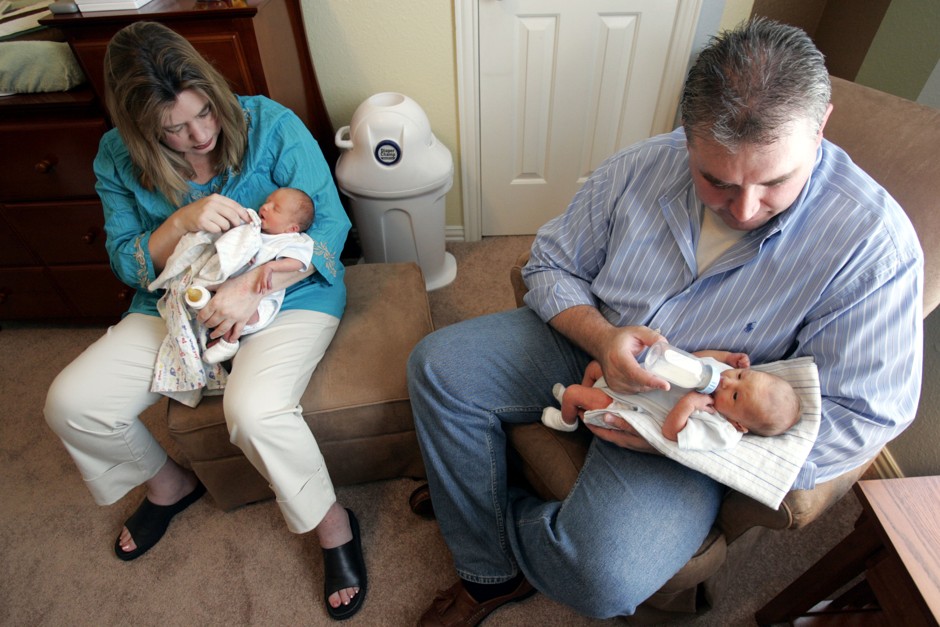 A mother and father hold twin sons at their home in Irving, Texas.