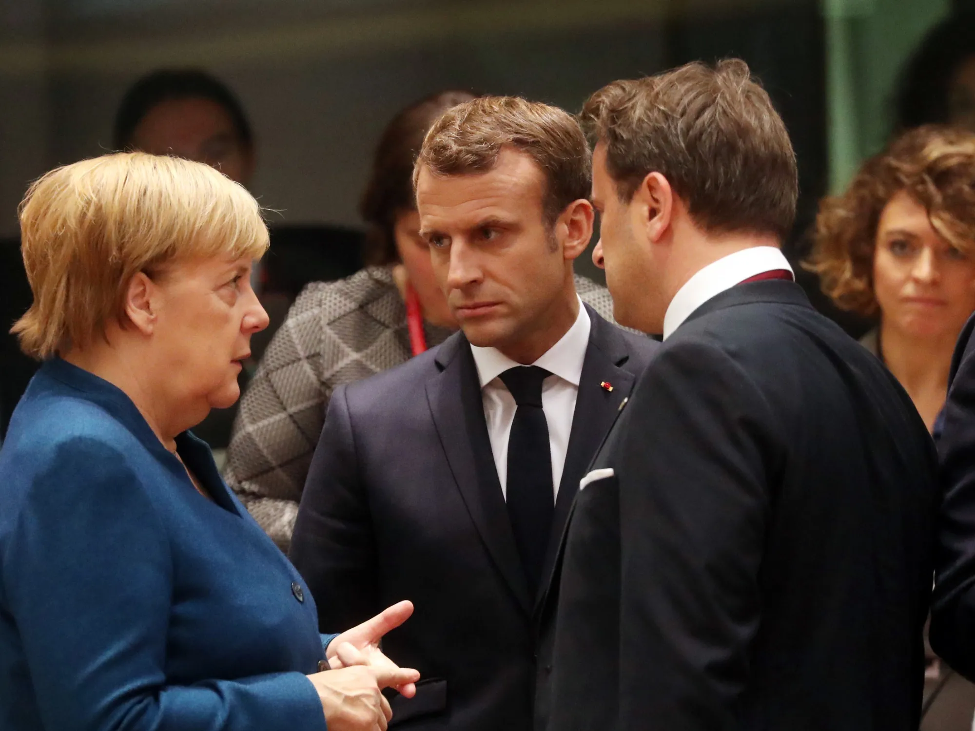 Angela Merkel speaks with Emmauel Macron and Xavier Bettel on Oct. 18.