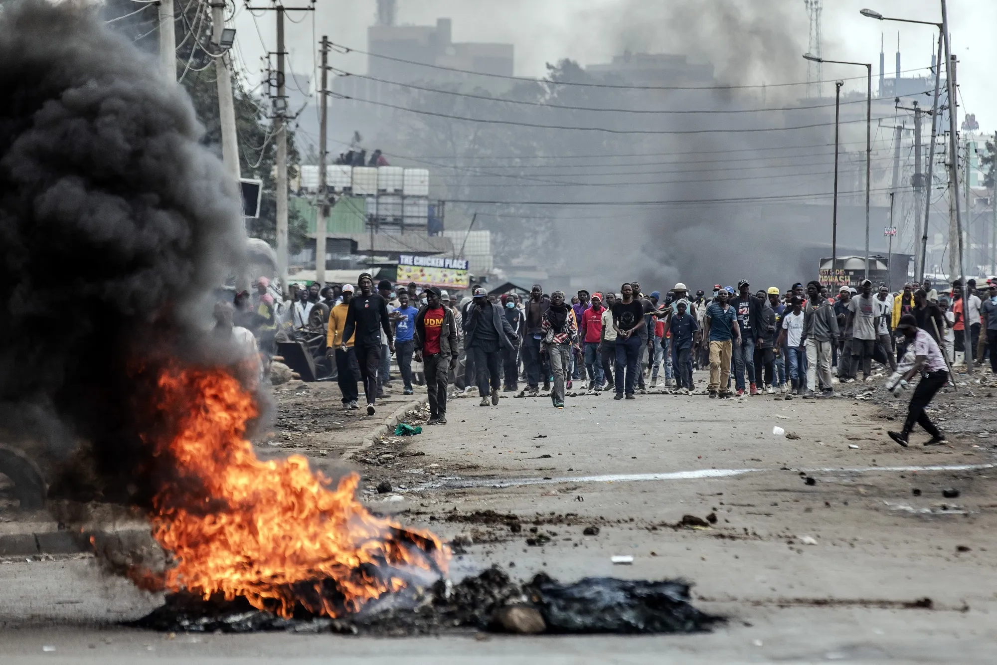 Kenyan opposition supporters react and throw stones towards Kenya Police officers during demonstrations in Nairobi, Kenya on July 12.