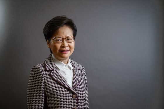Carrie Lam Defends Hong Kong Covid Curbs as Singapore Opens