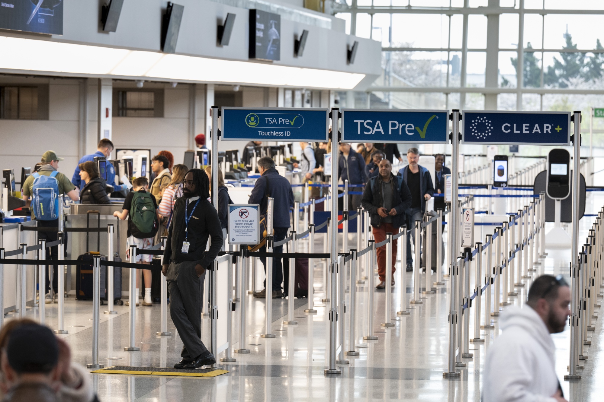 Travelers walk through TSA screening corridors at Ronald Reagan International Airport in Washington on March 30. Photographer: Roberto Schmidt/Getty Images