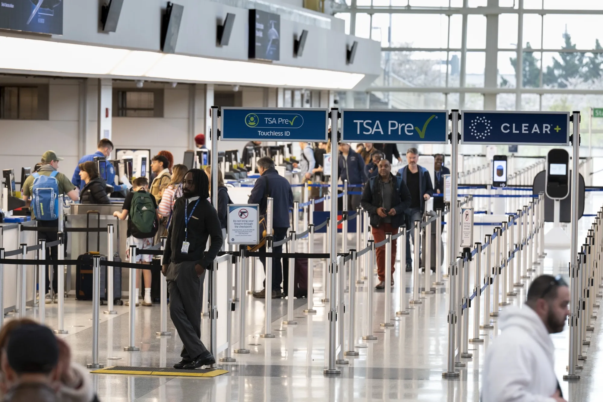 Travelers walk through TSA screening corridors at Ronald Reagan International Airport in Washington on March 30.