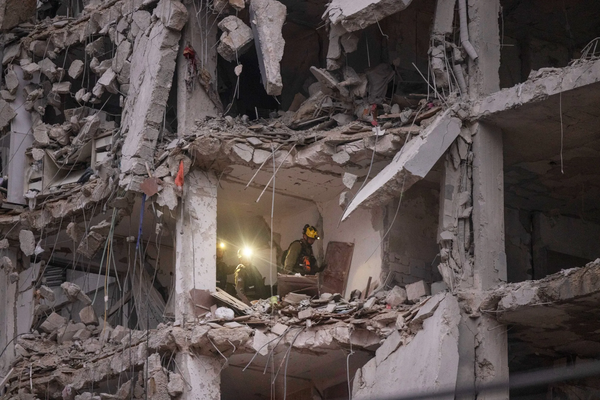 Israeli rescue forces search a building hit by a ballistic missile launched from Iran in Bat Yam, Israel, on&nbsp;June 15.