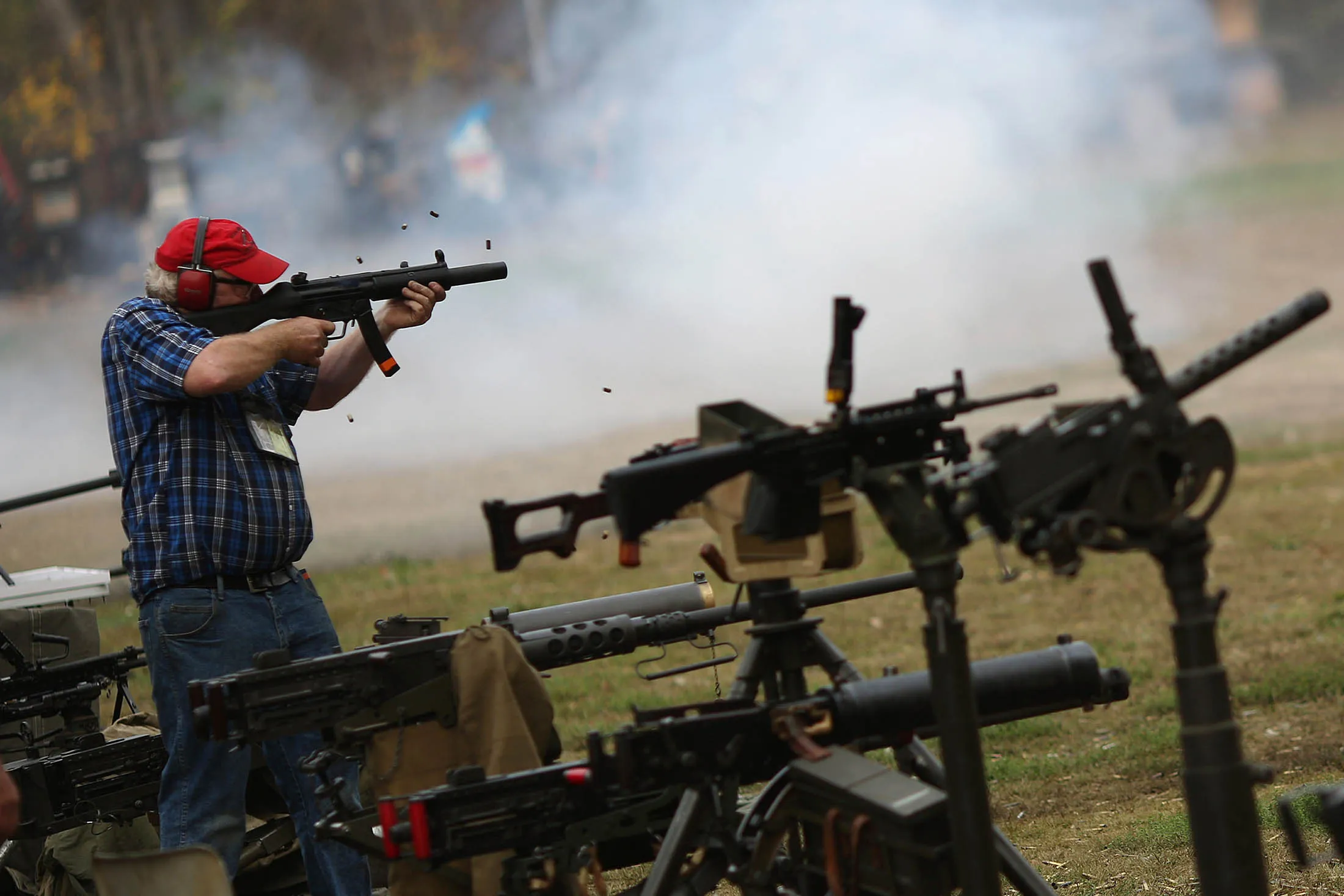 A participant fires a suppressed Heckler &amp; Koch MP5 submachine gun during the Fall 2015 Knob Creek Machine Gun Shoot in West Point, Kentucky, U.S., on Friday, Oct. 9, 2015. The Machine Gun Shoot is a three day bi-annual event that attracts gun dealers, collectors, and enthusiasts from all across America in what is considered one of the largest gun shows in the world dealing specifically with high caliber weaponry.
